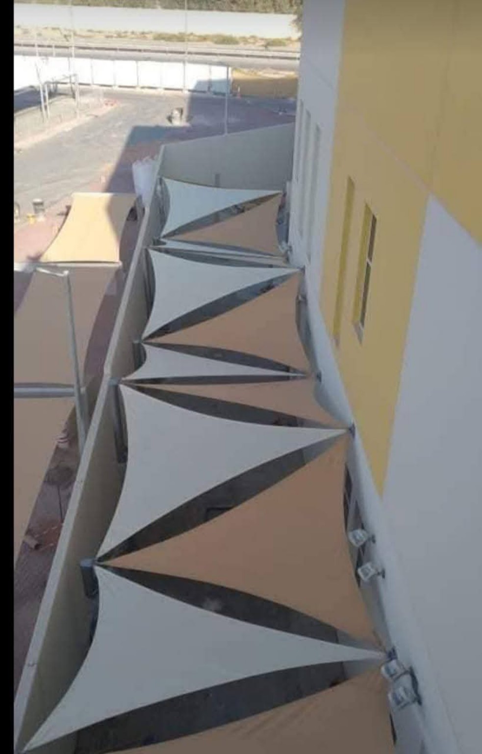 Alternating Triangle Sail Walkway Shade installed in the UAE